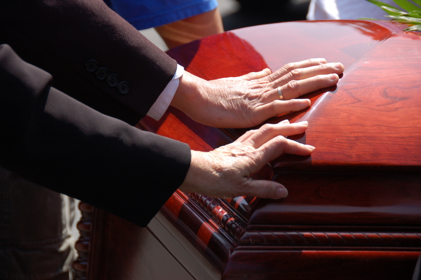 hand on coffin