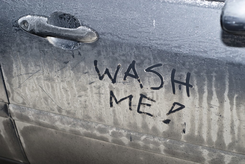 Wash me sign on dirty car